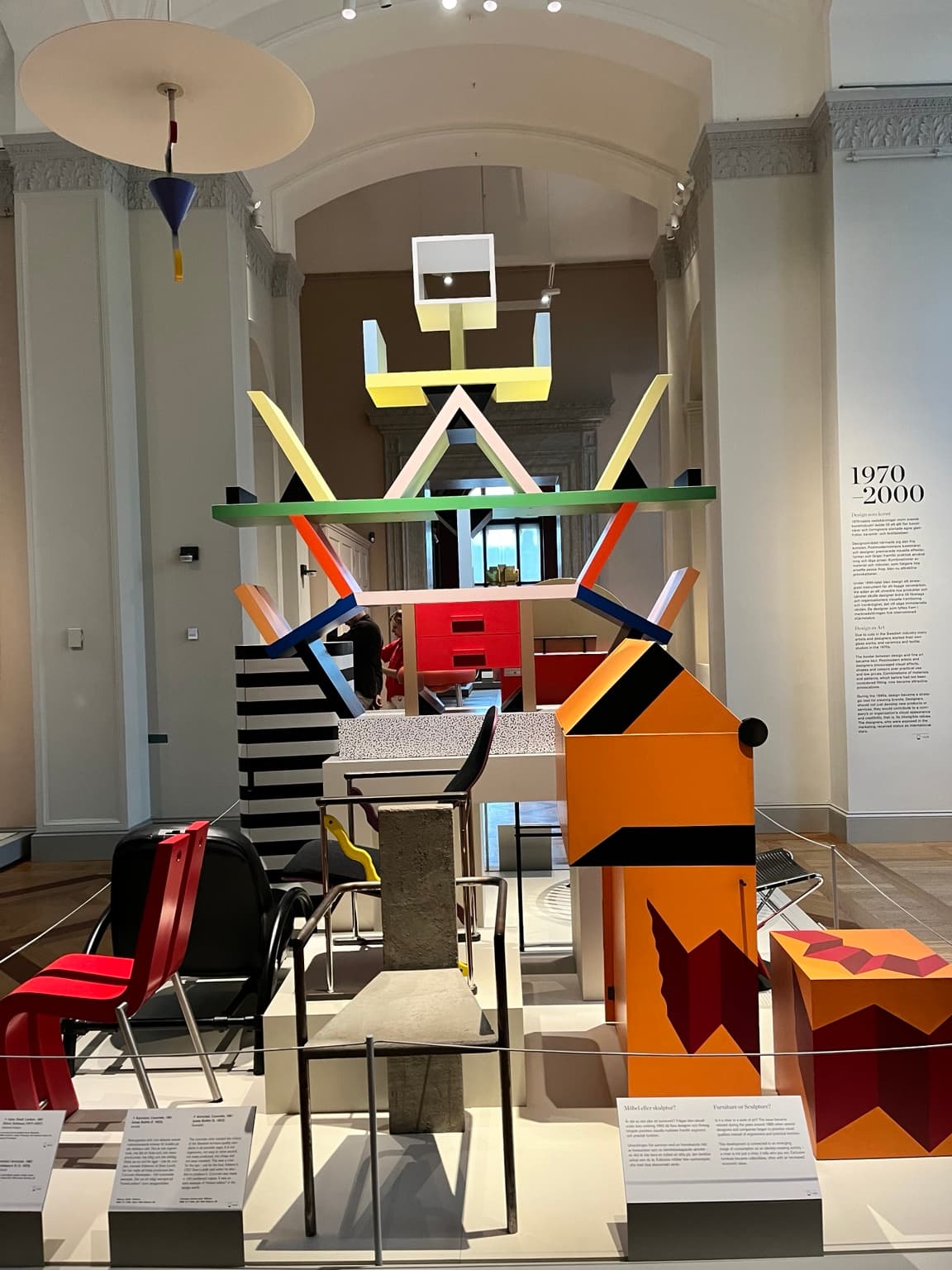 Editorial design photograph of colourful geometric shelving, sculptural furniture and chairs in a museum gallery
