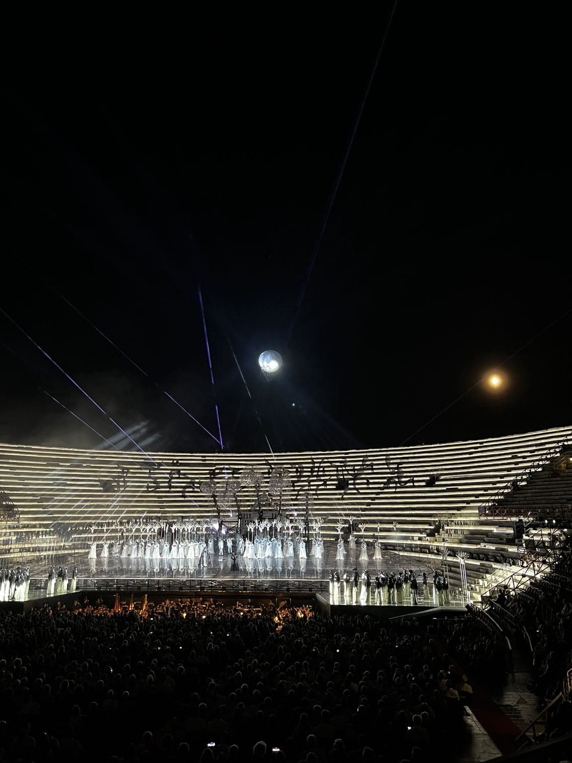 OperaAtlas original editorial photograph of an Arena di Verona performance beneath the night sky