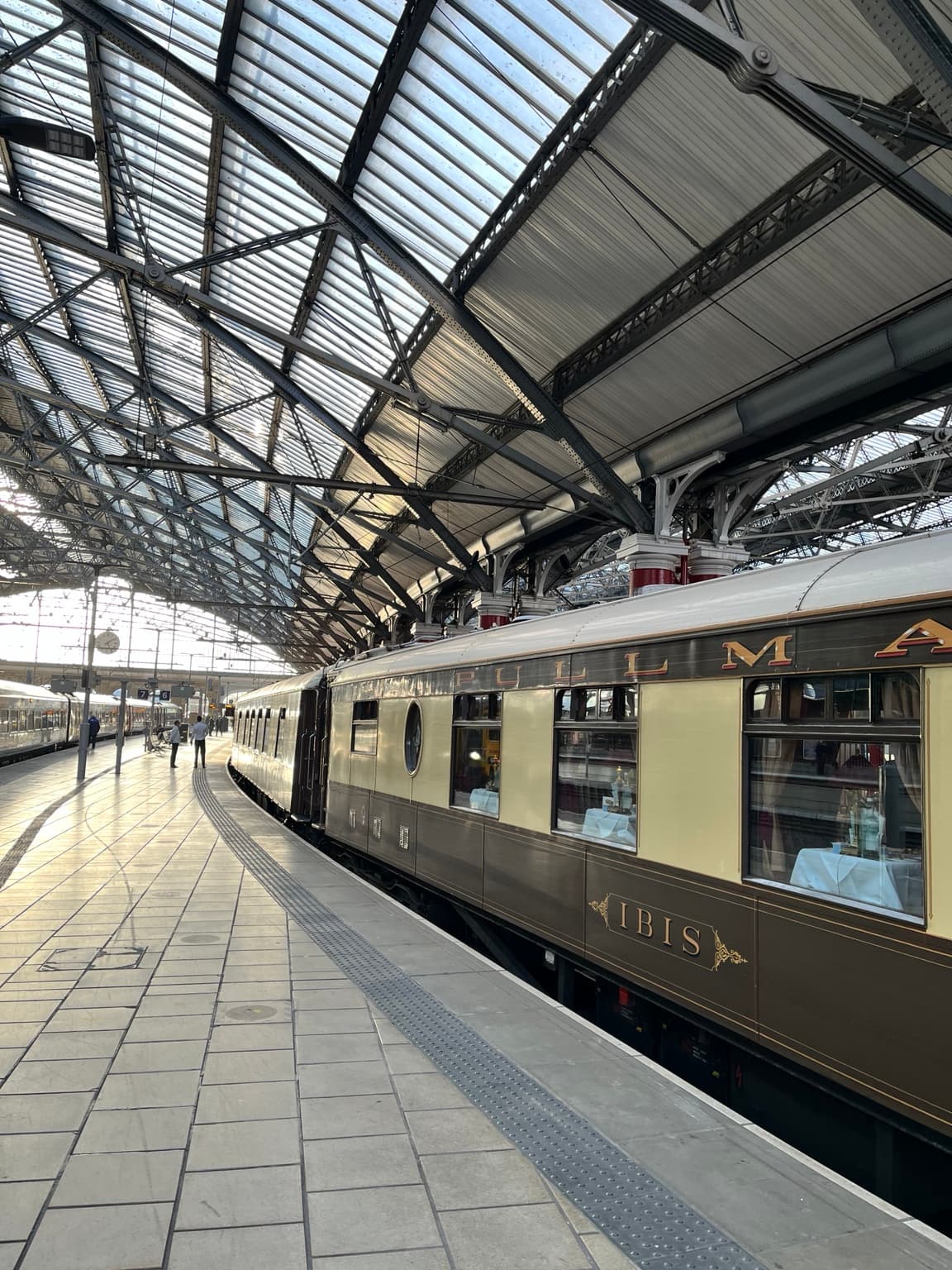 British Pullman carriages beside a covered station platform