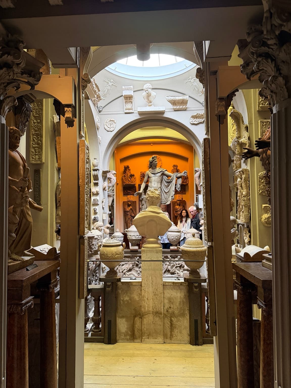 Sculptures, urns and architectural fragments beneath arches and a skylight at Sir John Soane’s Museum
