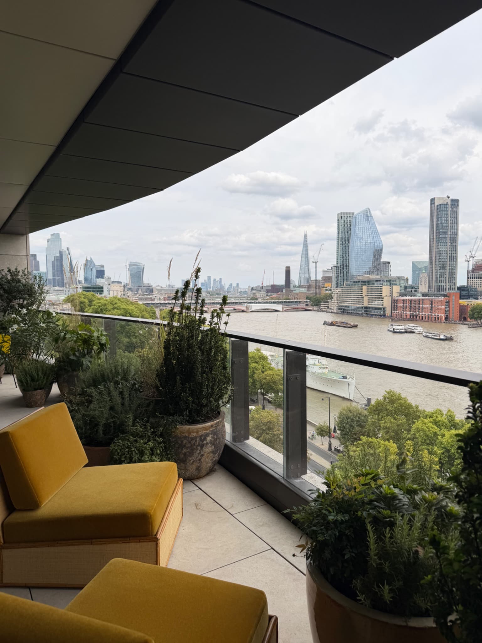 Terrace at St. Clement with yellow seating and a view across the Thames